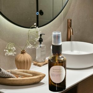 spray bottle of beard oil on bathroom vanity